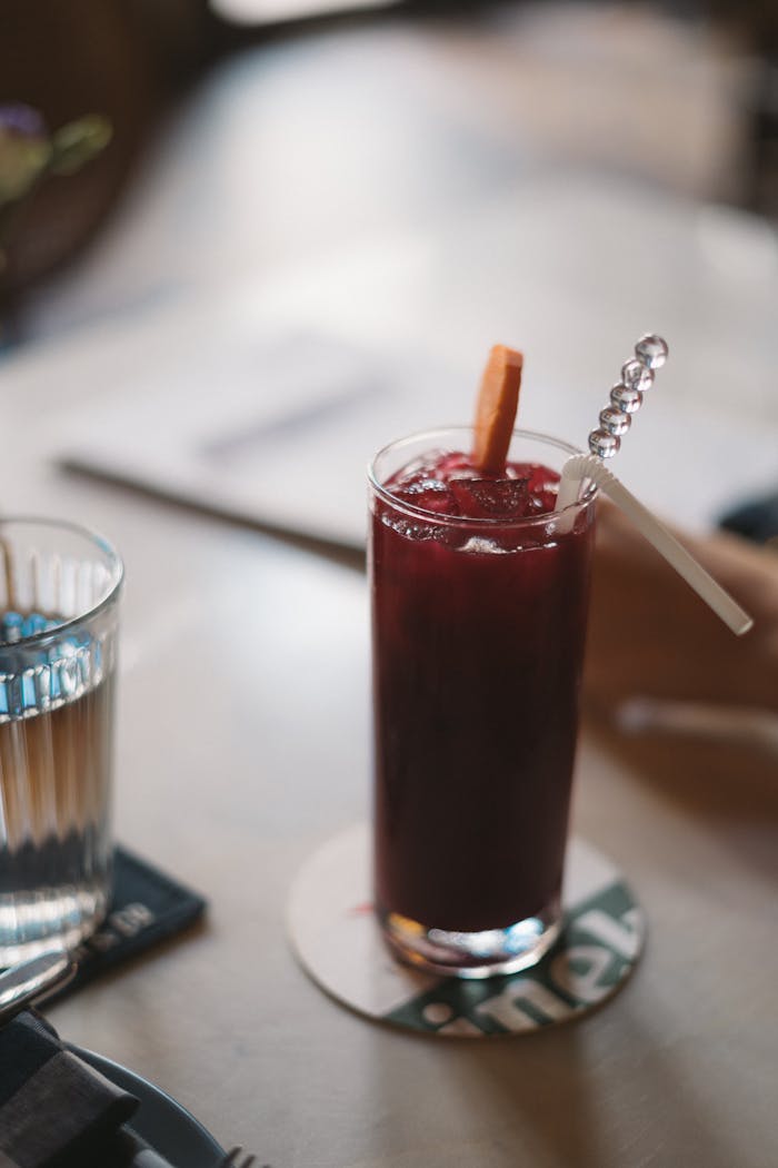 Close-up of a berry juice with straws on a table, perfect for a refreshing moment indoors.
